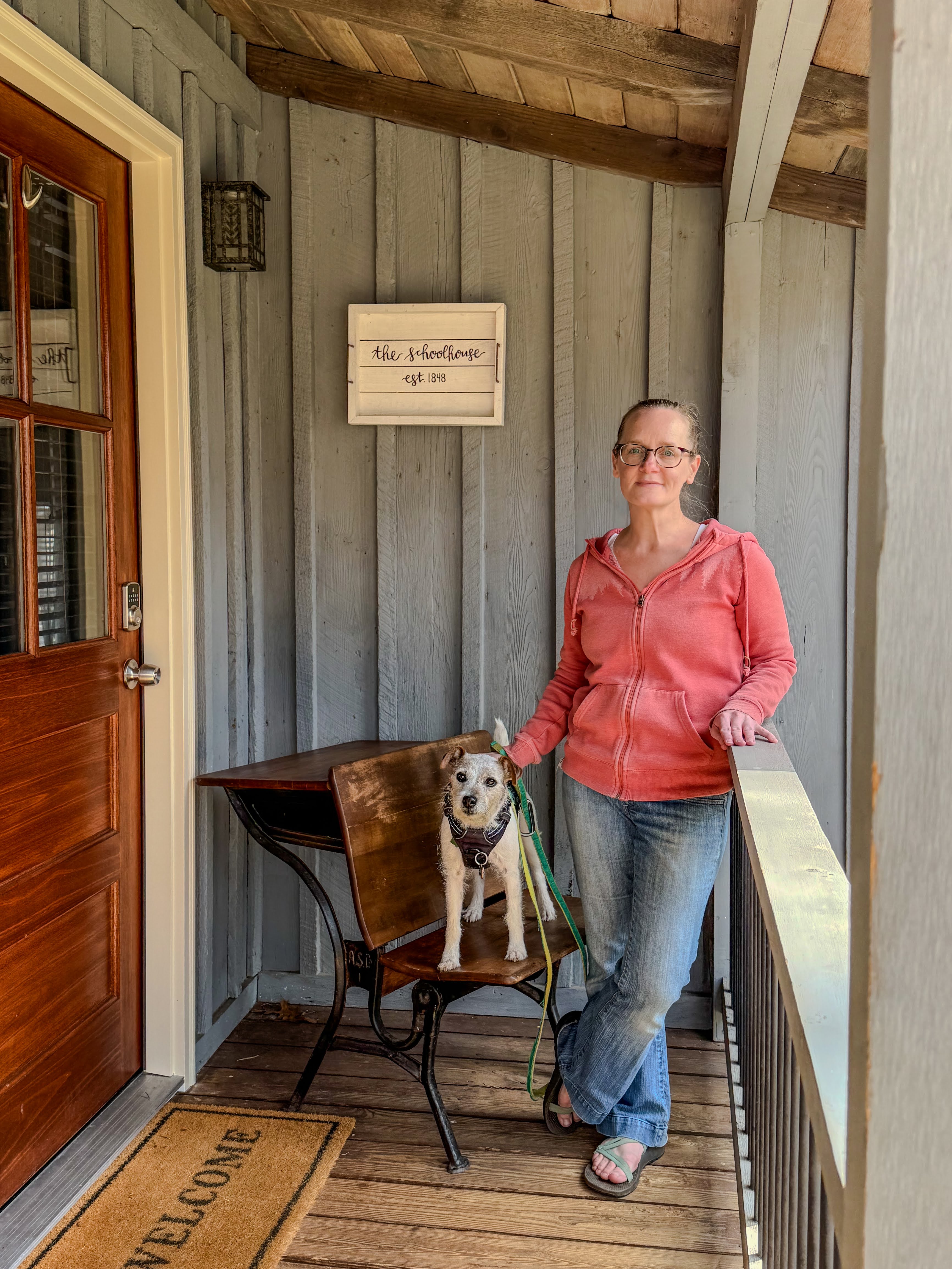 Callie Wheat standing in front of the Schoolhouse Cottage