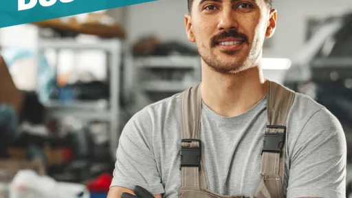 A promotional graphic for LiftFund featuring a man in a gray shirt and work overalls standing confidently with arms crossed in what appears to be a workshop. Large text reads &ldquo;Invest in Your Small Business.&rdquo; The LiftFund logo is displayed in the top right corner. A red banner across the bottom says &ldquo;0% Interest Rate Loans,&rdquo; alongside the City of San Antonio Economic Development Department logo.