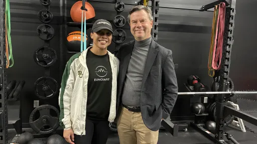 Alyssa Nichols stands with Alex Counts inside Eunoiafit