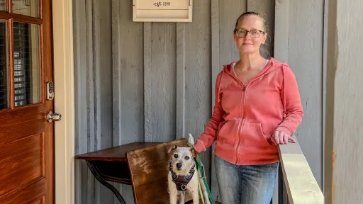 Callie Wheat standing in front of the Schoolhouse Cottage