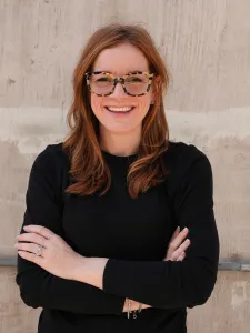 Picture of woman with red hair and arms crossed.