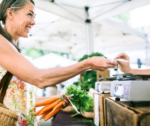 Woman paying at farmers market
