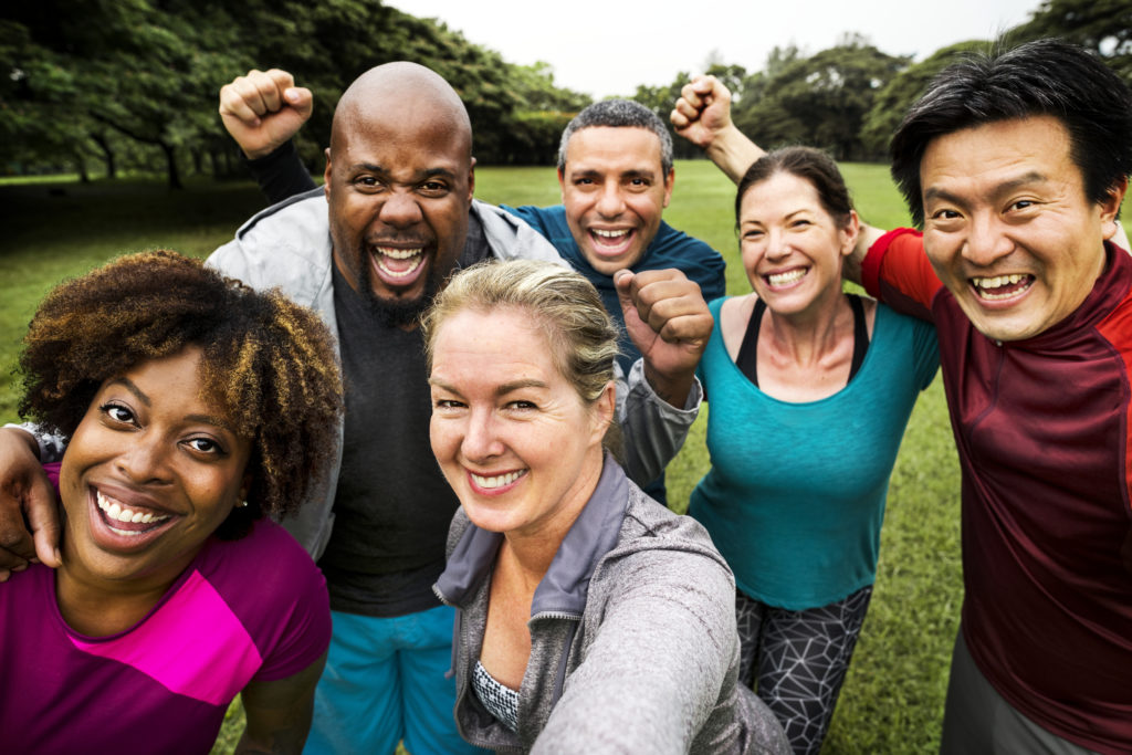 Group of cheerful diverse friends in the park